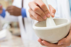 a person using a mortar and pestle