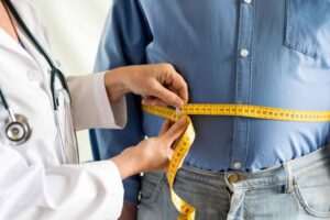 a doctor measuring a man's stomach