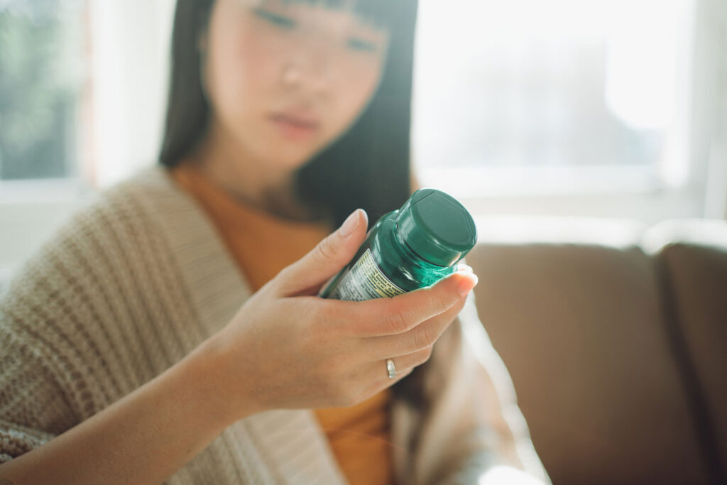 a woman holding a green bottle