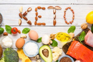 a keto diet with food on a white wood surface