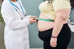 a doctor measuring a woman's belly