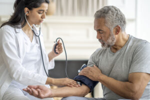 a doctor checking a man's blood pressure