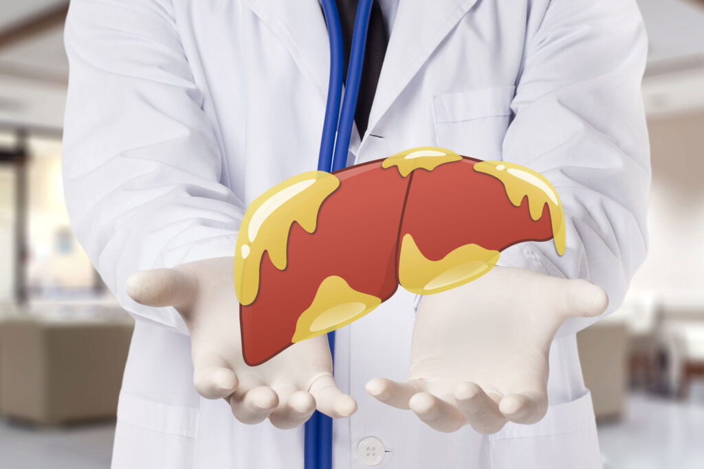 a person in a white coat holding a cartoon liver