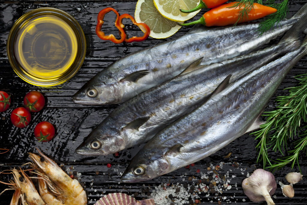 a group of fish with vegetables and spices