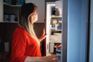 lady looking in fridge