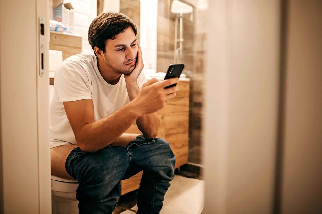 a man sitting on a toilet