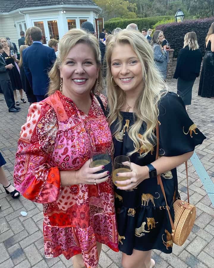 dos mujeres con bebidas en la mano posando para la cámara