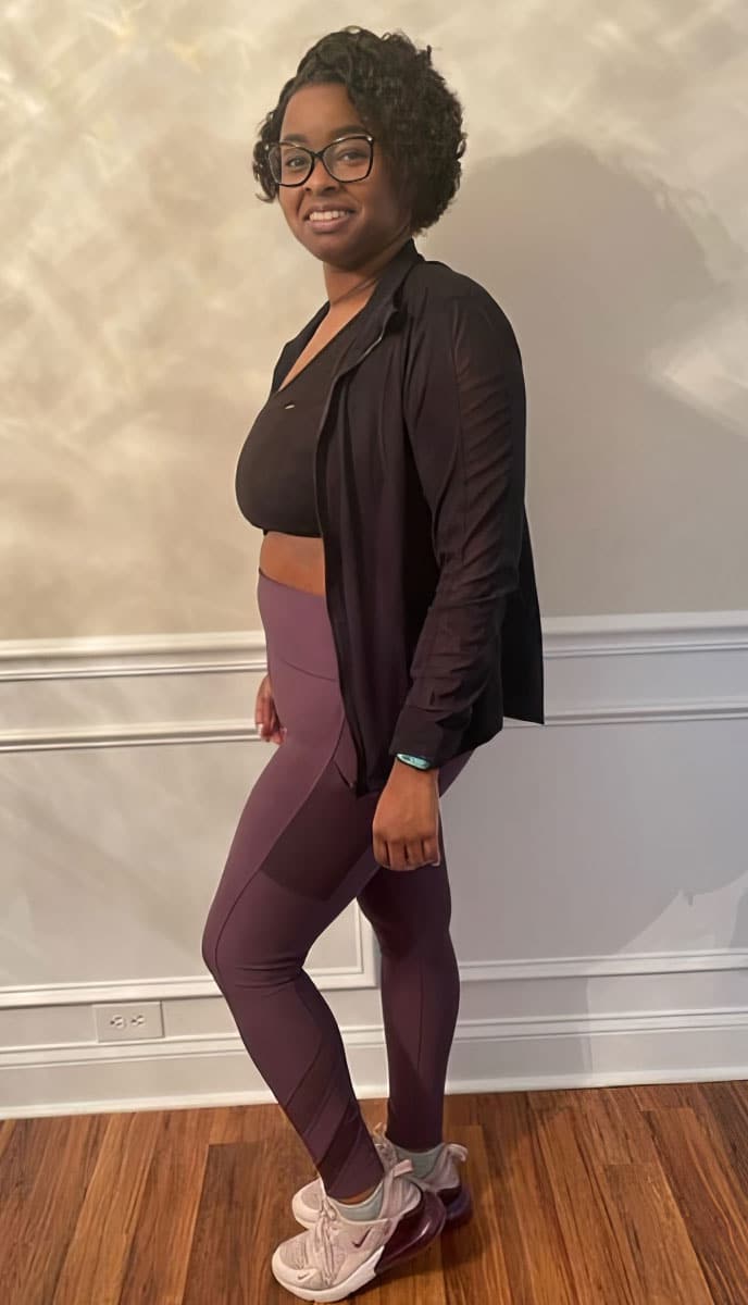 a woman in a black shirt and purple leggings