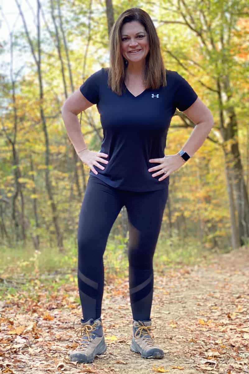 a woman standing in a forest