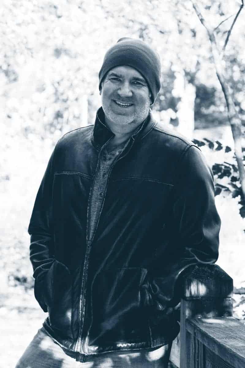 a man in a beanie and a leather jacket