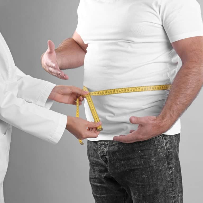 a person measuring a man's waist