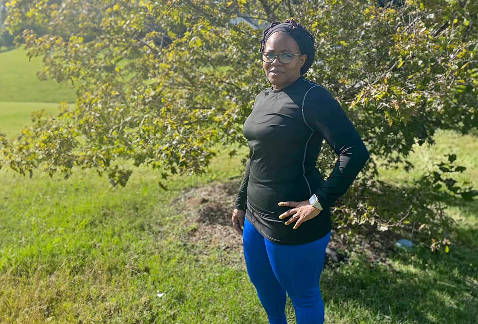 a woman standing in a grassy area