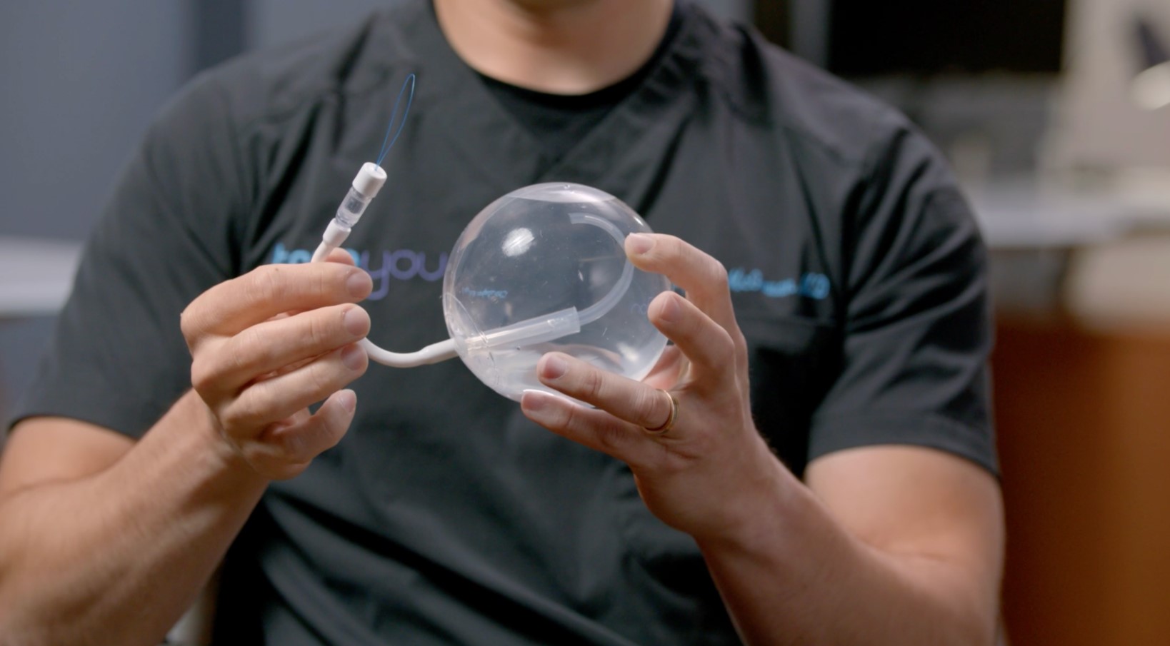 a person holding a gastric balloon